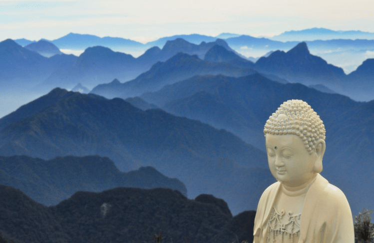 Mountainscape and Buddha statue.