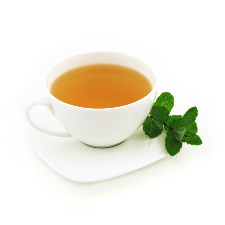 Cup of tea with herbs beside it.