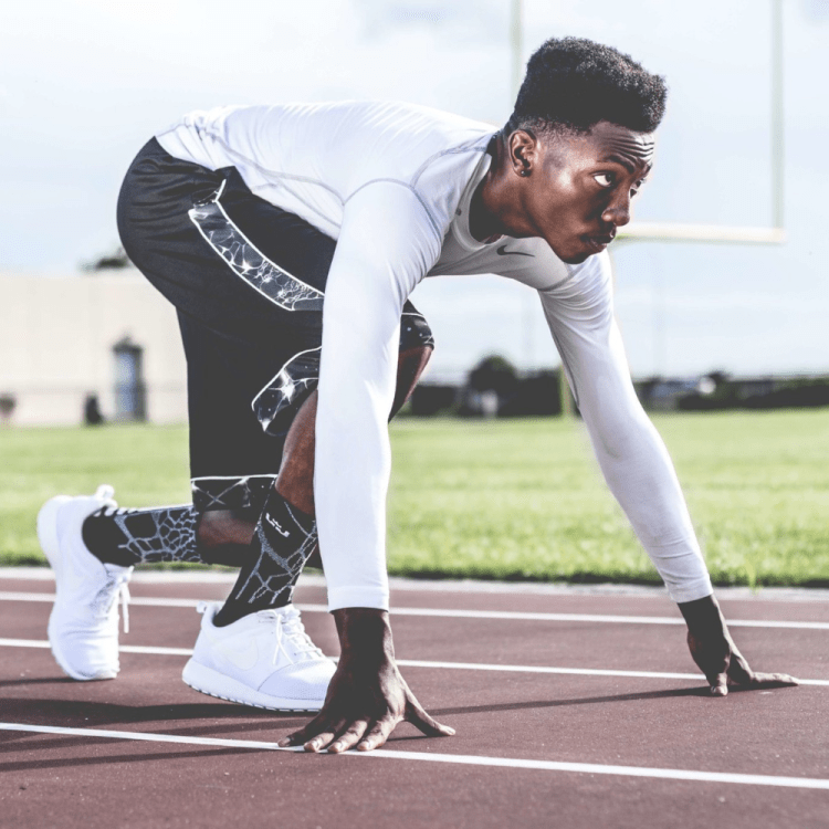 Man about to run on a race track.