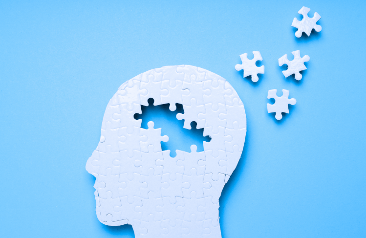 Plain puzzle of a head, pieces scattered around the brain.