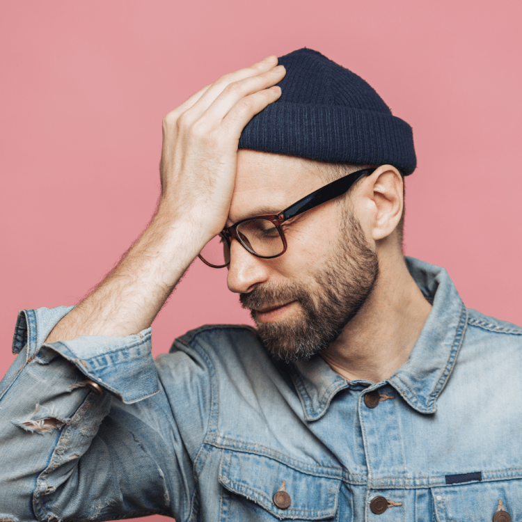 Man holding his head in his hand.
