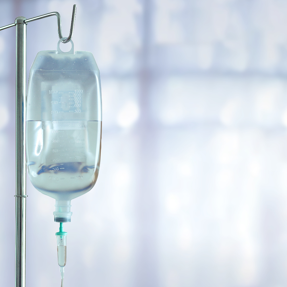 A bag of fluids for an IV injection, hanging from a hospital pole.